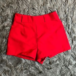 Red high waisted shorts with zipper detail in the back.